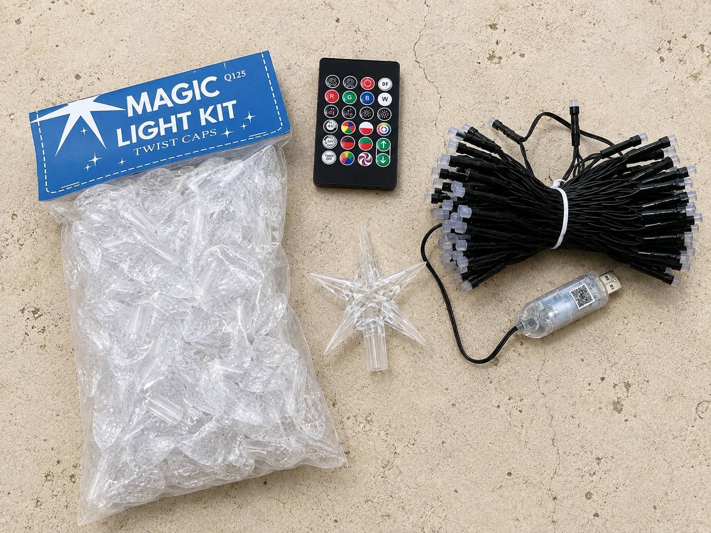 Kit contents laid out: twist caps bag, remote, star topper and LED string