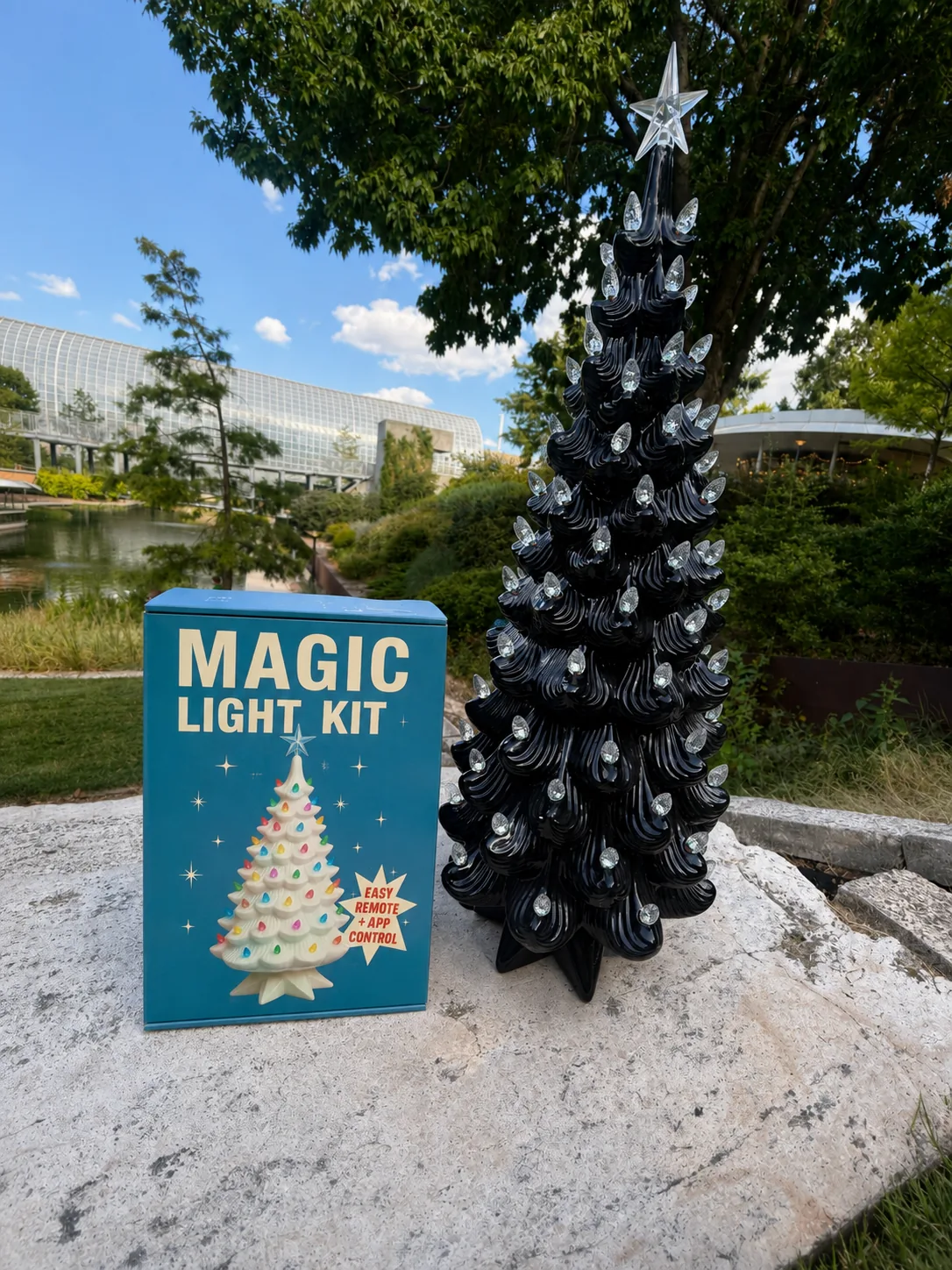 Black ceramic tree with clear bulbs beside the Magic Light Kit box outdoors