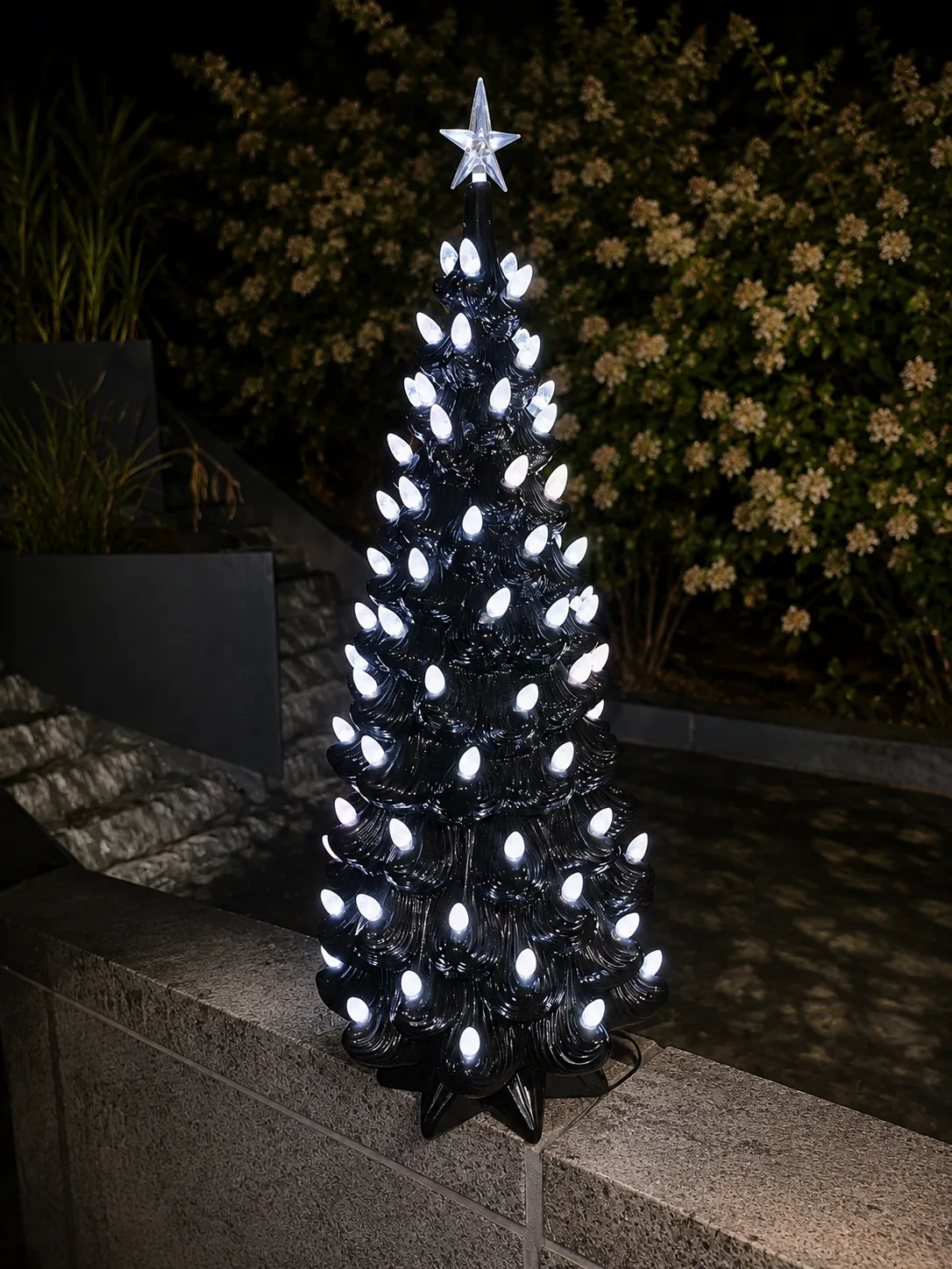 Ceramic tree lit in cool white at night